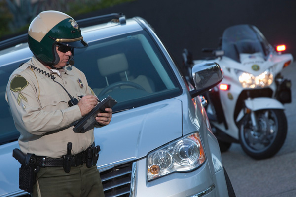police officer writing a ticket for a traffic infraction